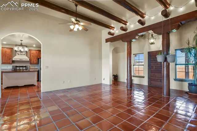 a view of a hallway with wooden floor and a kitchen