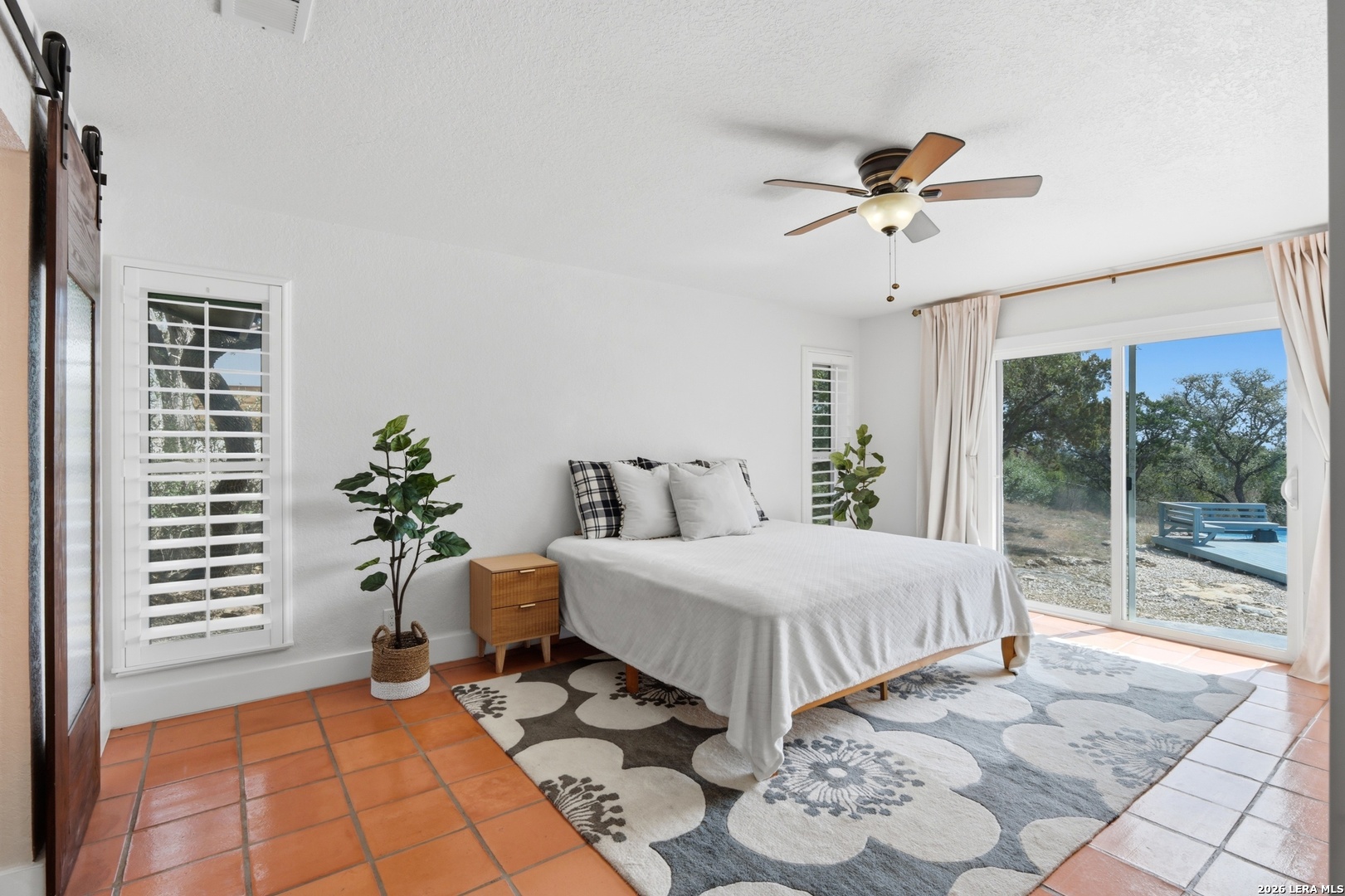 10206 Rafter S Trail Helotes, TX 78023 - Photo 29 of 49 a bedroom with double bed and a window