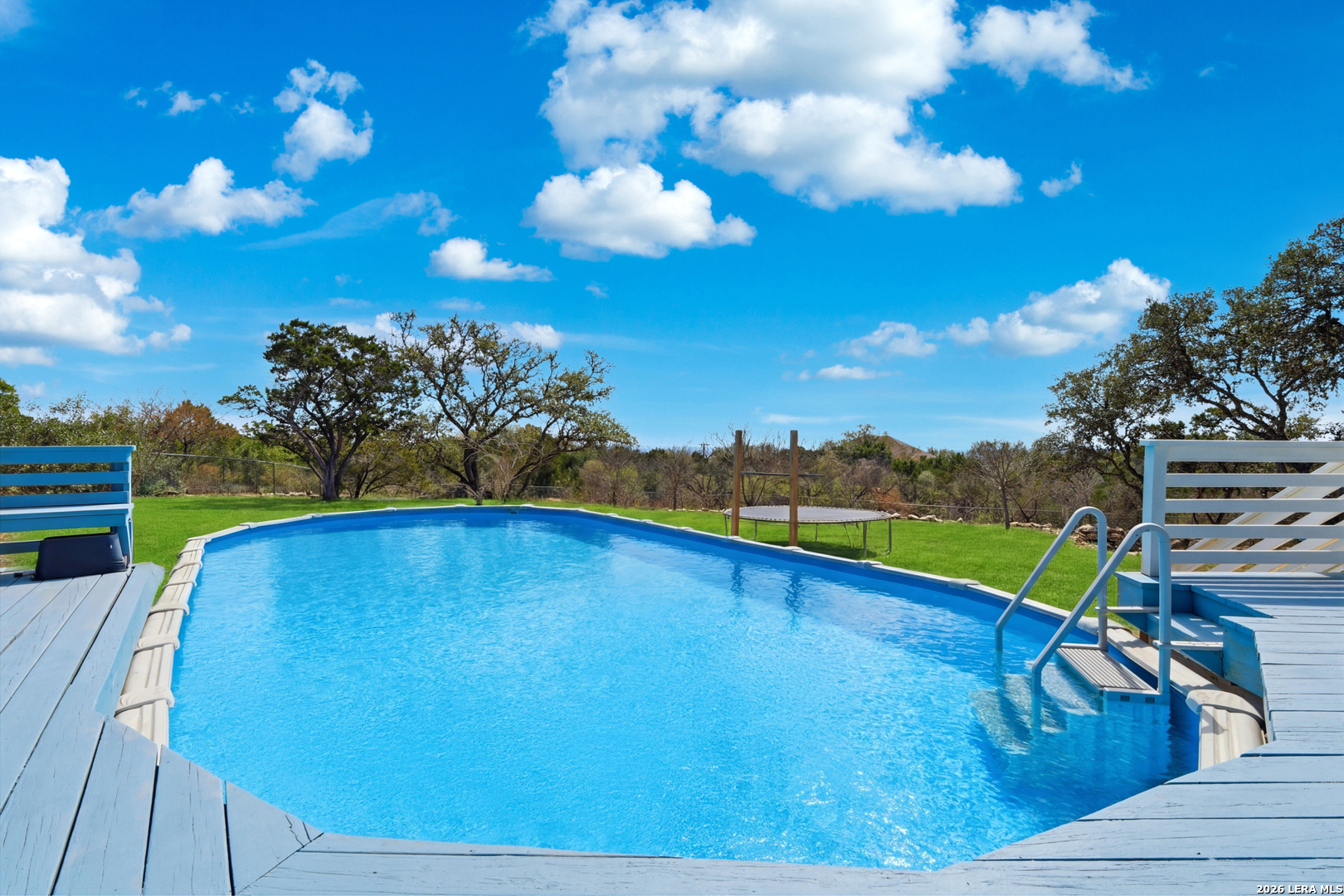 10206 Rafter S Trail Helotes, TX 78023 - Photo 35 of 49 a view of a swimming pool with an outdoor seating and yard in back