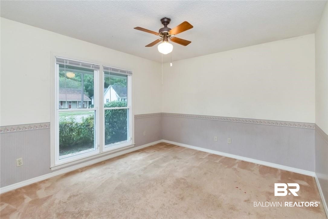 6109 Timberly Road North Mobile, AL 36609 - Photo 19 of 26 Carpeted spare room featuring a textured ceiling and ceiling fan