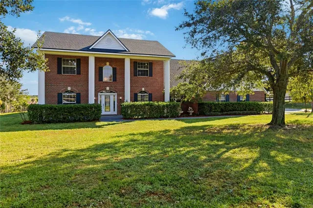 a front view of house with yard and green space