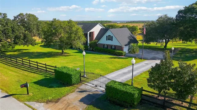 an aerial view of a house with swimming pool garden and patio