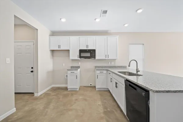 a kitchen with a sink stove and cabinets