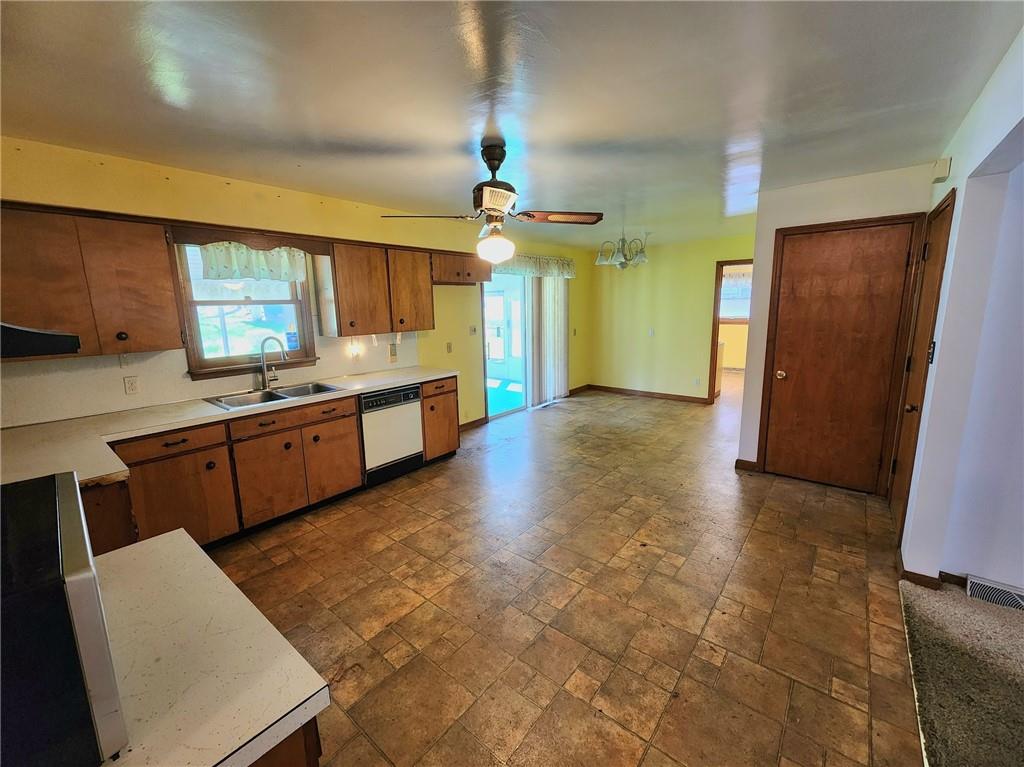 3060 Valley View Road Clark, PA 16113 - Photo 6 of 24 a large kitchen with kitchen island a sink stainless steel appliances a counter space and a window