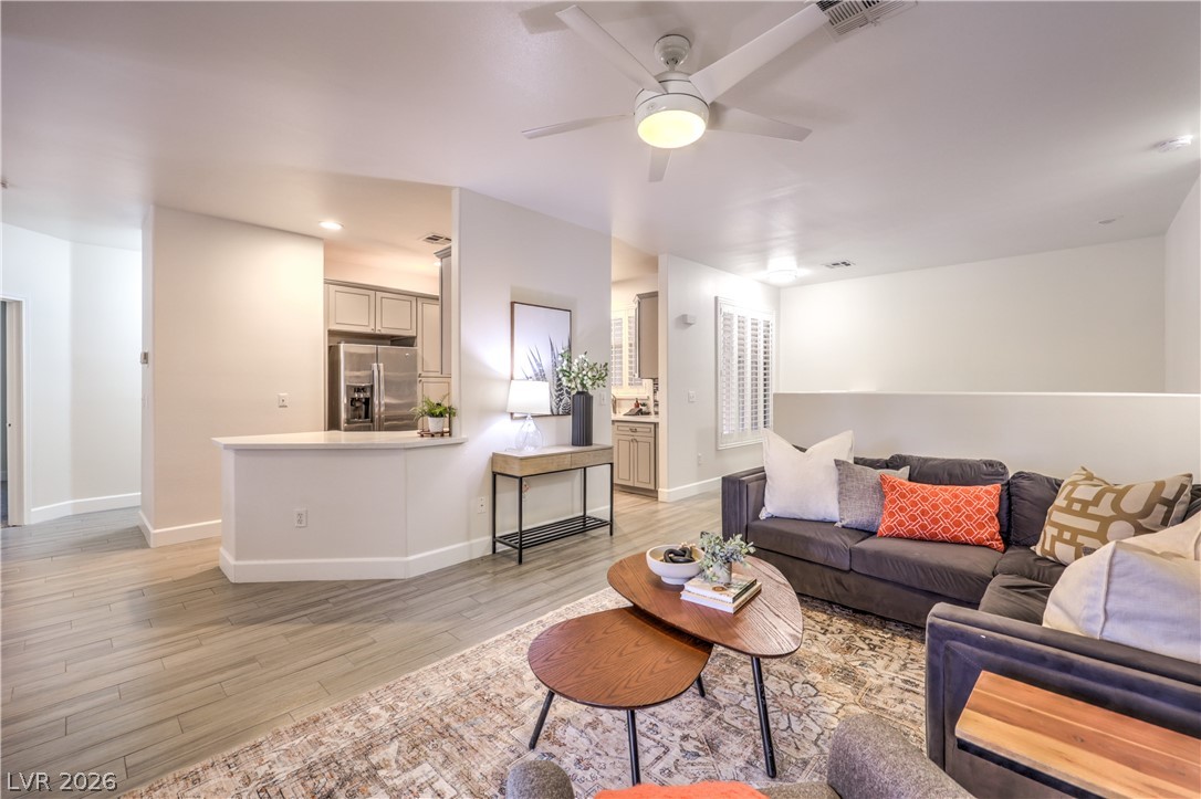 2050 West Warm Springs Road, Unit 1421 Henderson, NV 89014 - Photo 45 of 45 An open floorplan seamlessly connects the well-lit living area to a modern kitchen, ideal for entertaining.