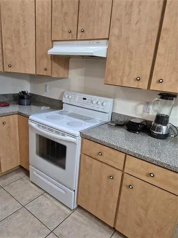 a kitchen with granite countertop cabinets and white appliances