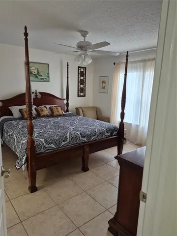 a bedroom with a bed and a mirror on dresser