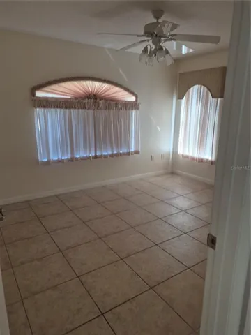 a view of a livingroom with a ceiling fan and window