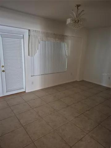 an empty room with a empty space and windows