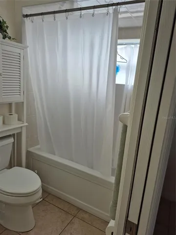a bathroom with a shower and a toilet