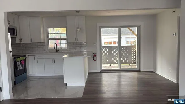 a view of a kitchen with a sink and a window