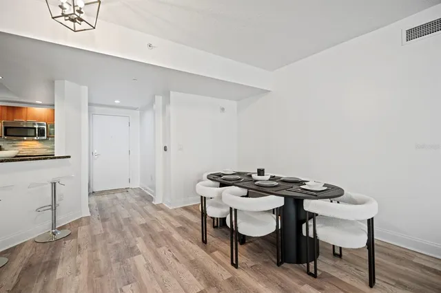 a view of a dining room with furniture and wooden floor