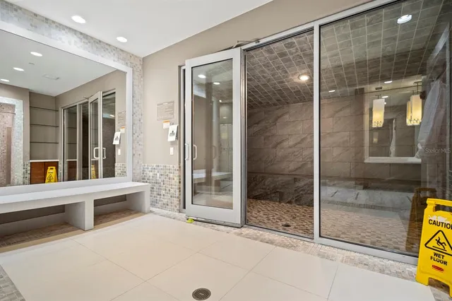 a view of a bathroom with a glass door shower and a sink