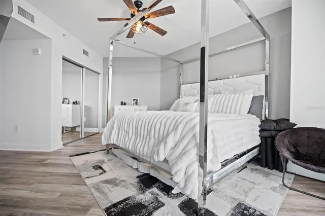 a bedroom with a bed and wooden floor