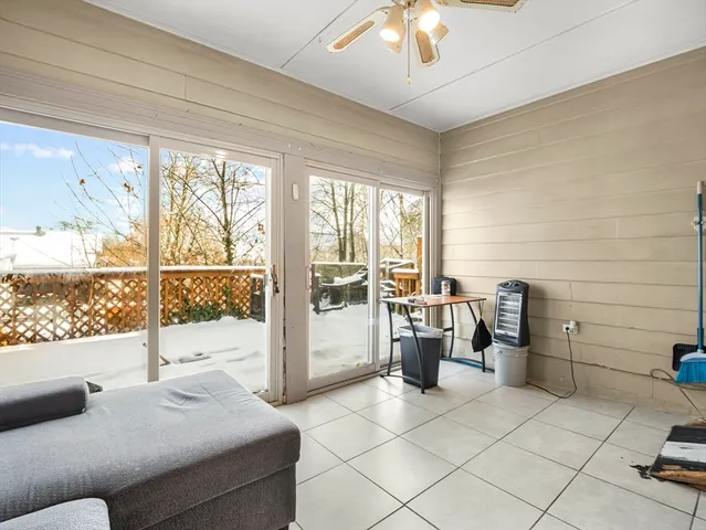 a living room with furniture and a floor to ceiling window