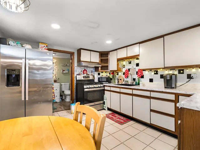 a kitchen with stainless steel appliances kitchen island granite countertop a sink and cabinets