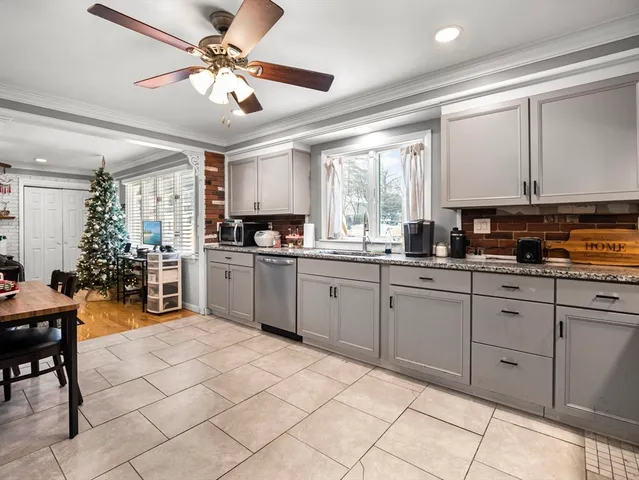 a kitchen with a stove a sink and a refrigerator