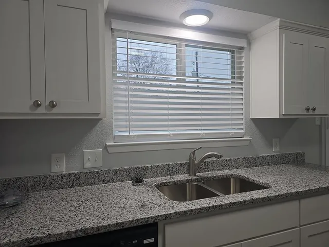a kitchen with a sink and cabinets