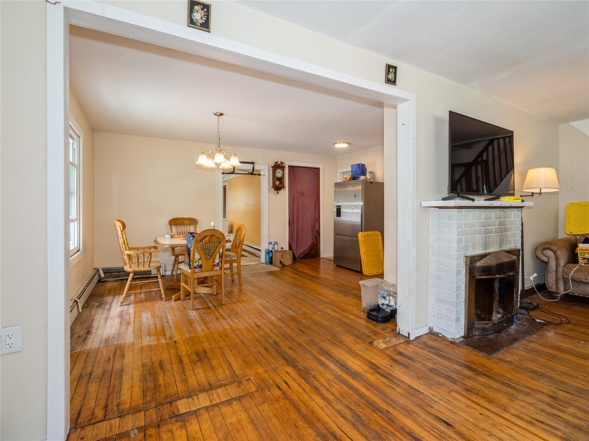 413 Vassar Road Poughkeepsie, NY 12603 - Photo 11 of 38 a living room with furniture a fireplace and a flat screen tv