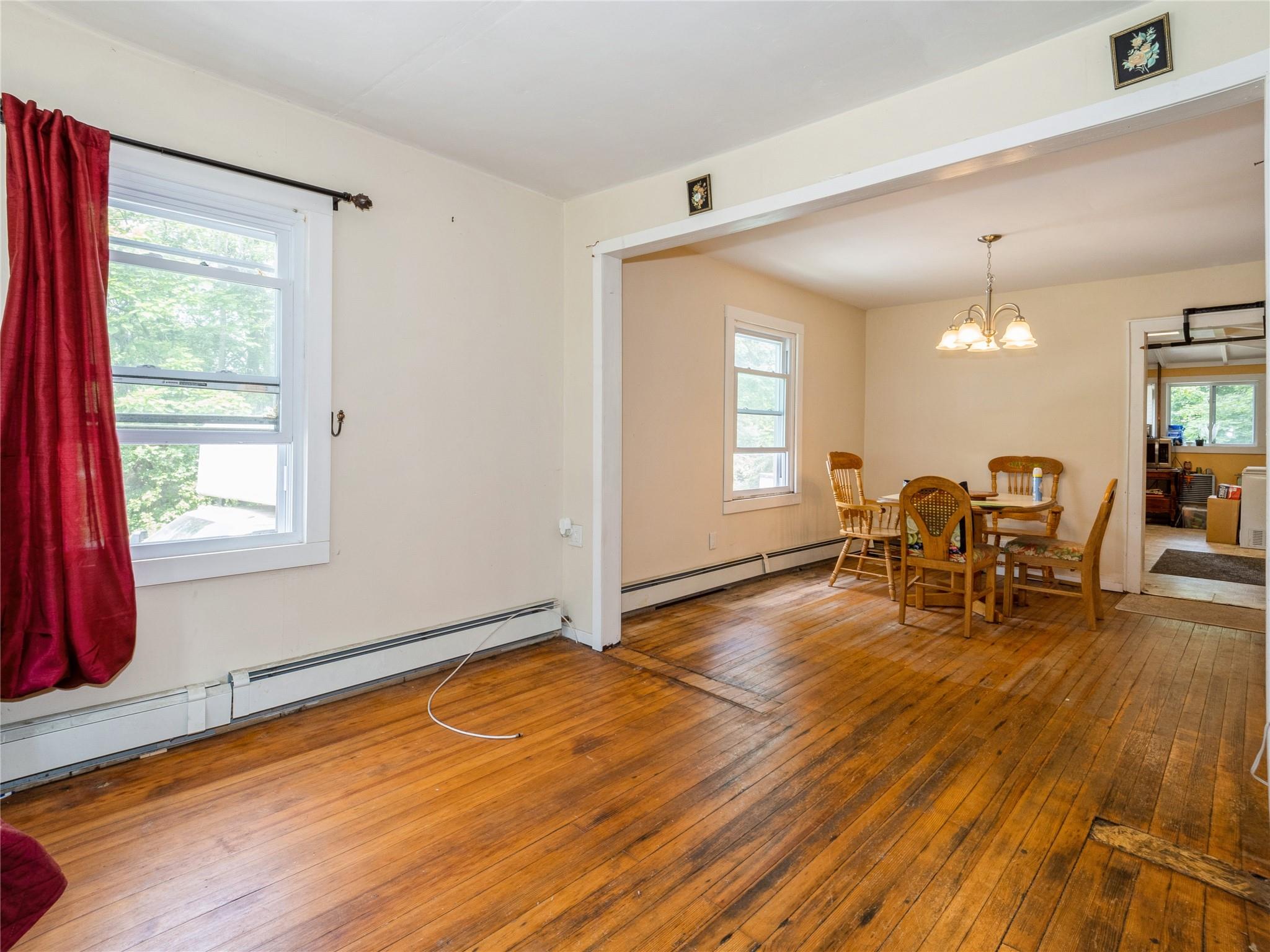 413 Vassar Road Poughkeepsie, NY 12603 - Photo 12 of 38 a view of a room with dining room and wooden floor