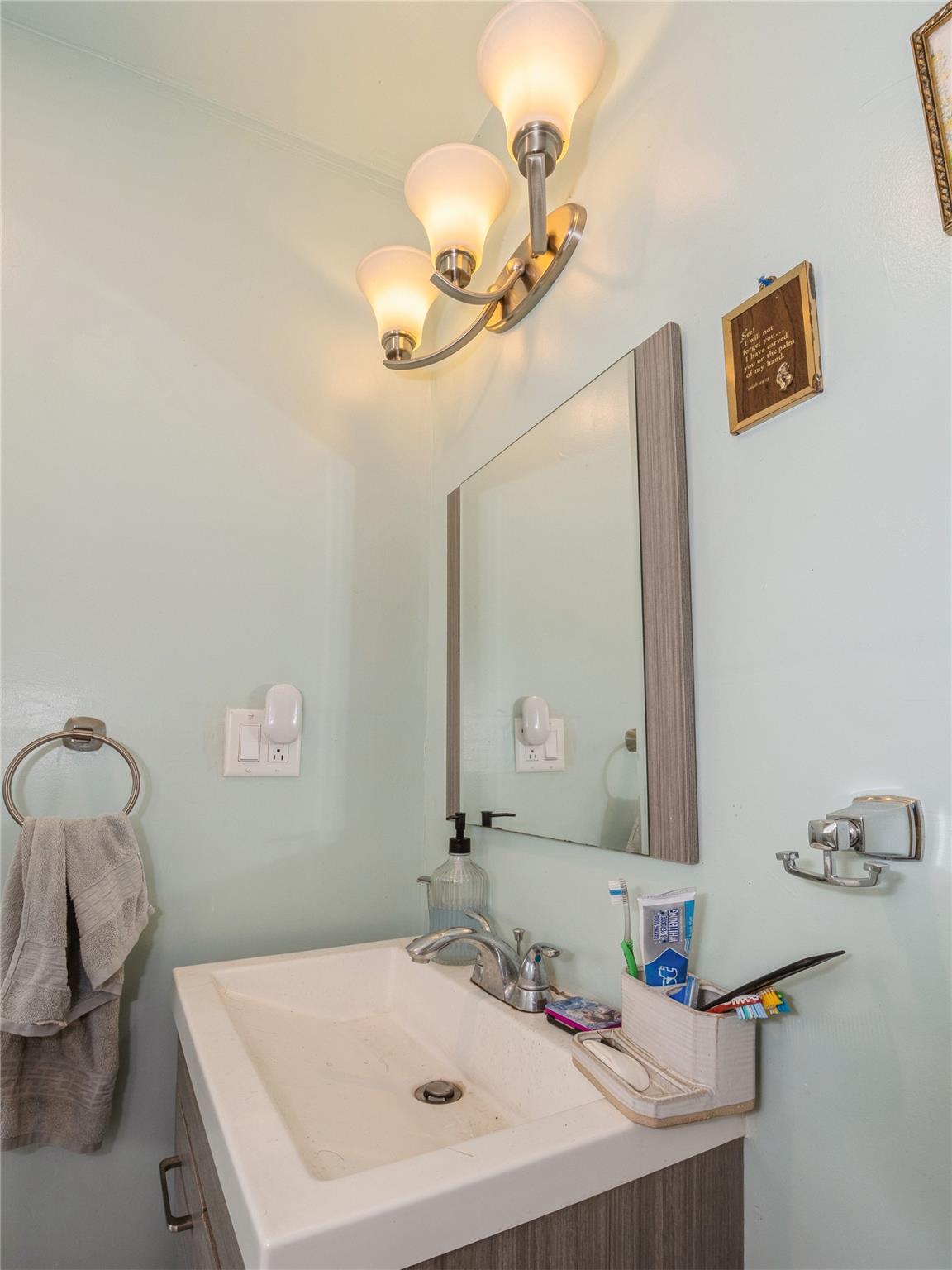 413 Vassar Road Poughkeepsie, NY 12603 - Photo 18 of 38 a bathroom with a sink and a mirror