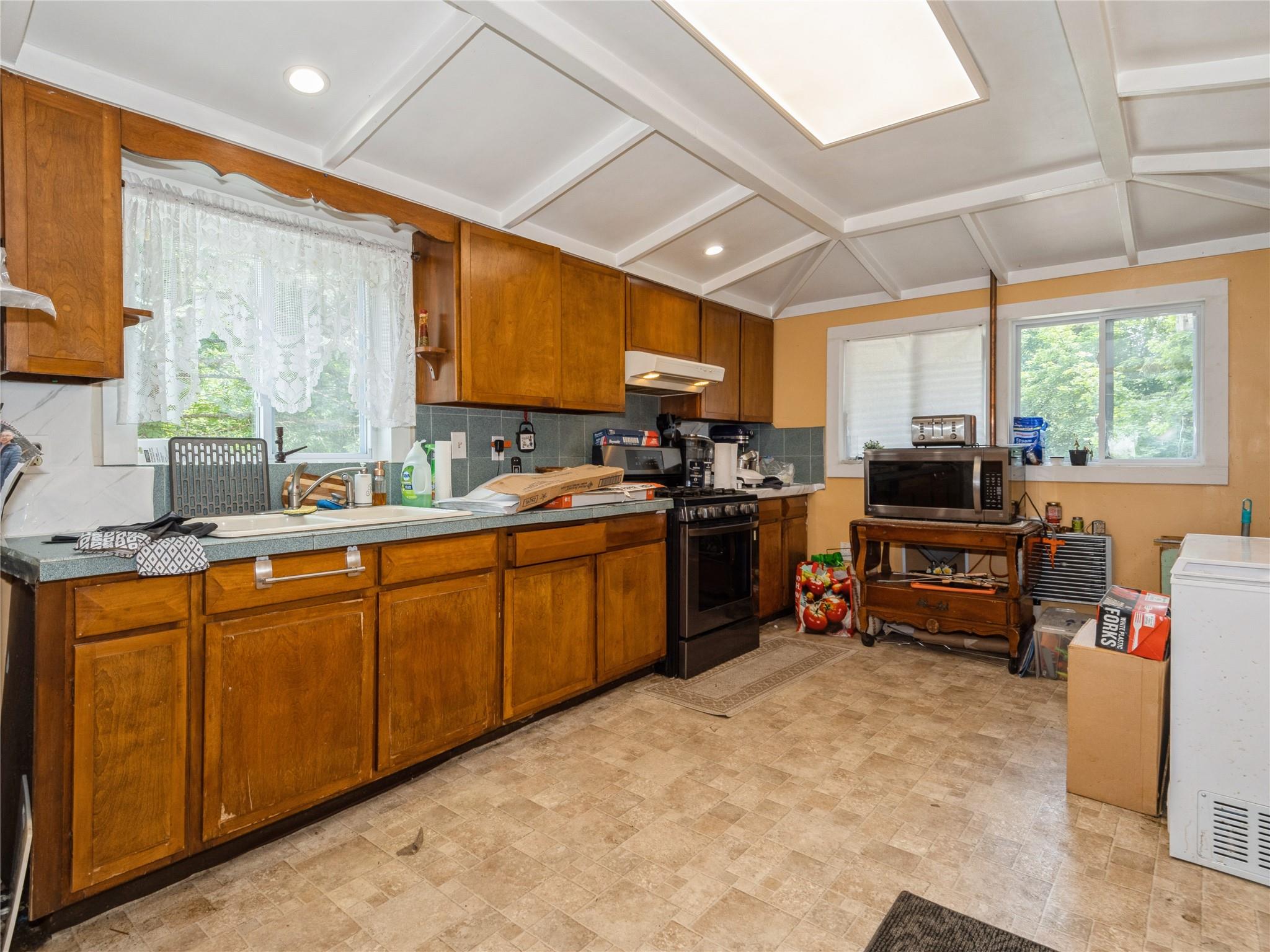 413 Vassar Road Poughkeepsie, NY 12603 - Photo 20 of 38 a kitchen with sink a window and cabinets