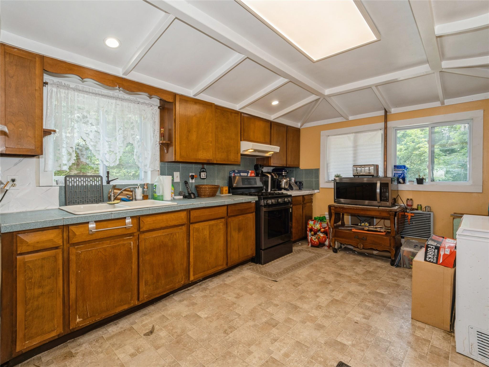 413 Vassar Road Poughkeepsie, NY 12603 - Photo 27 of 38 a kitchen with furniture a window and stainless steel appliances