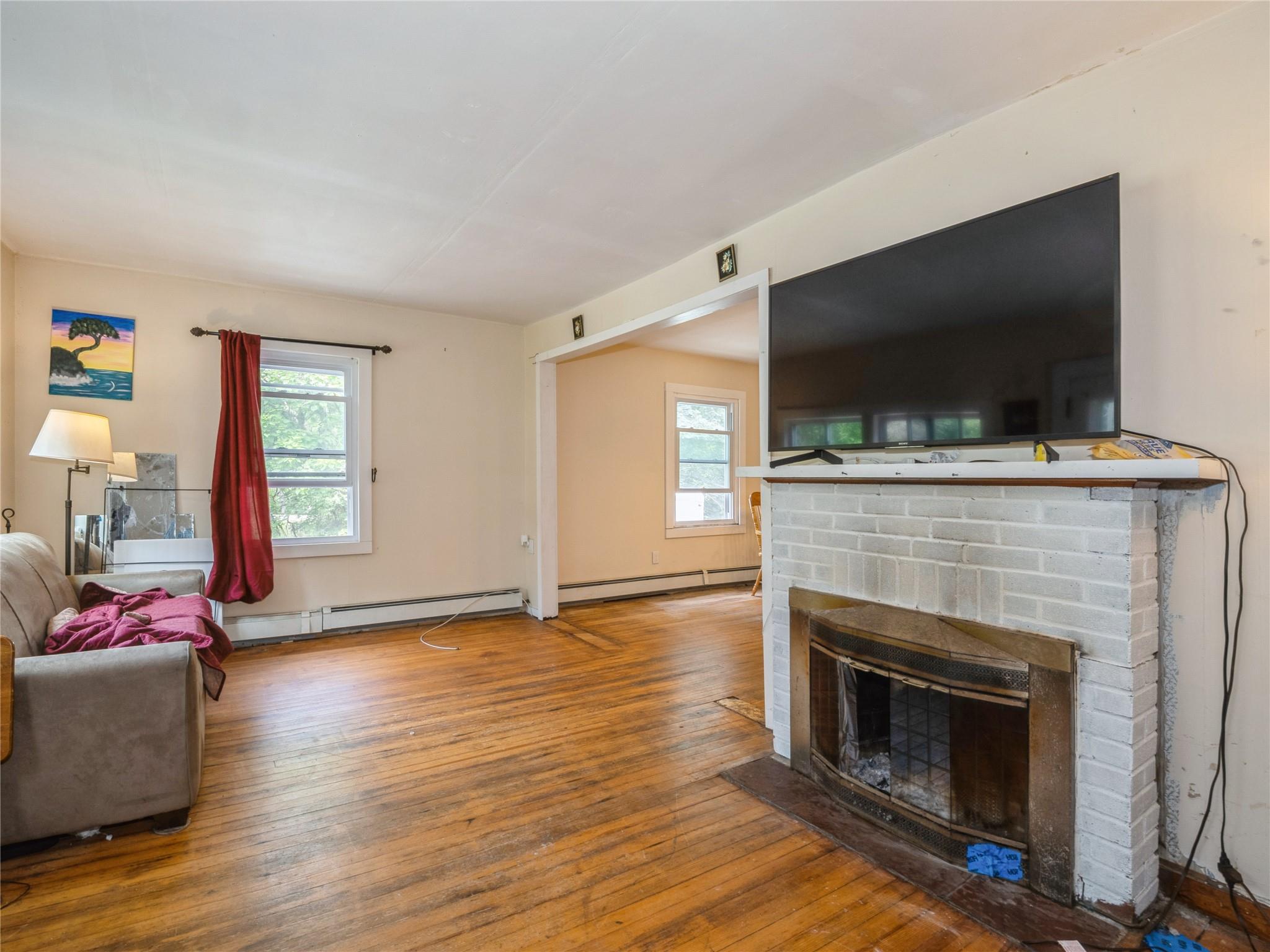 413 Vassar Road Poughkeepsie, NY 12603 - Photo 5 of 38 a living room with a flat screen tv and a fireplace