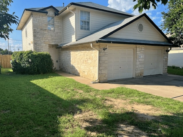 View of side of home featuring stone siding, driveway, and a garage
