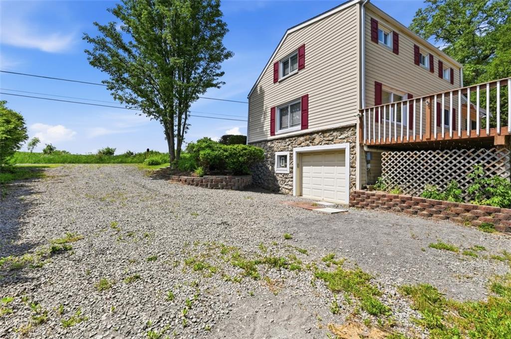 123 Cemetery Road Slippery Rock, PA 16057 - Photo 32 of 33 The other oversized driveway and integral garage provide ample parking and easy access, while the home's elevated setting offers privacy and space.