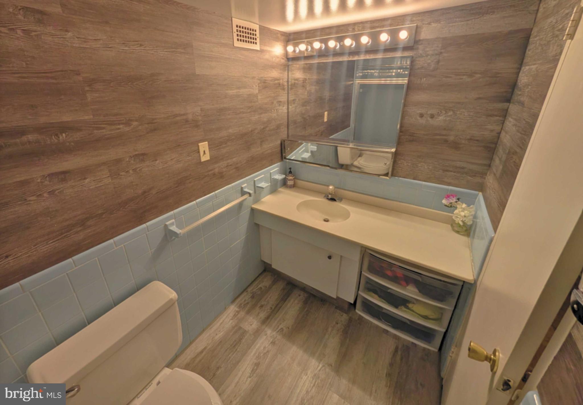 5101 River Road, Unit 405 Bethesda, MD 20816 - Photo 17 of 20 a bathroom with a sink and a shower