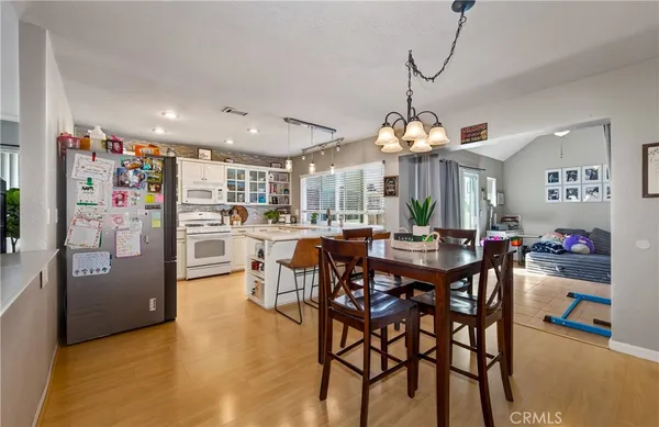 a view of a dining room with furniture and chandelier