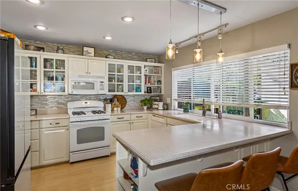 a kitchen with a stove a sink and a refrigerator