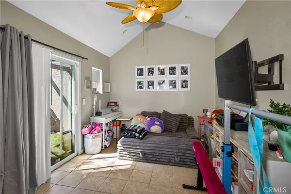 a bedroom with furniture and a flat screen tv