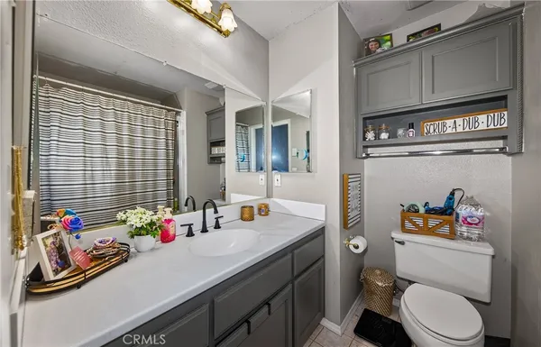 a bathroom with a sink mirror vanity and toilet