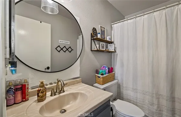 a bathroom with a sink mirror and toilet