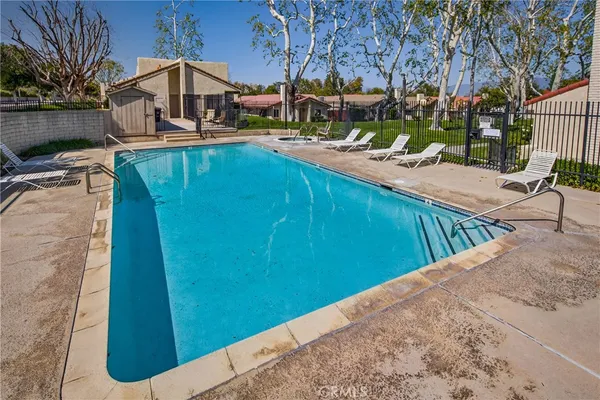 a view of swimming pool with outdoor seating and a patio