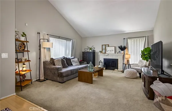 a living room with furniture a window and a flat screen tv