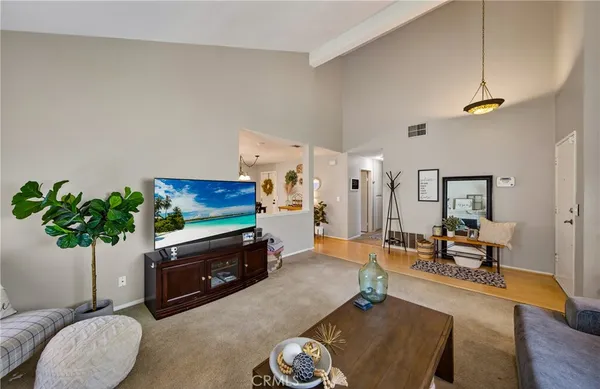 a living room with furniture potted plant and a fireplace