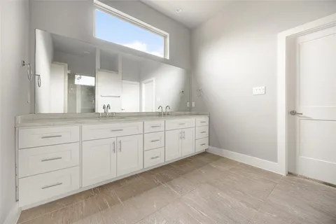 a spacious bathroom with a granite countertop sink and a mirror