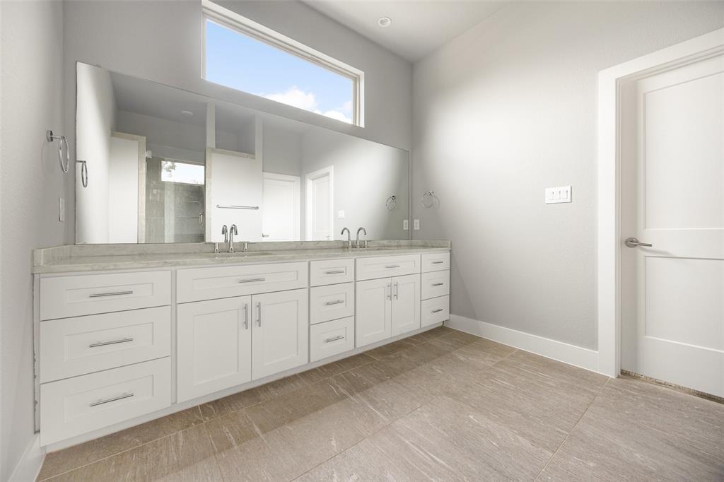 4226 Roseland Avenue, Unit 201 Dallas, TX 75204 - Photo 14 of 24 a spacious bathroom with a granite countertop sink and a mirror