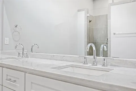a bathroom with a double vanity sink and a mirror