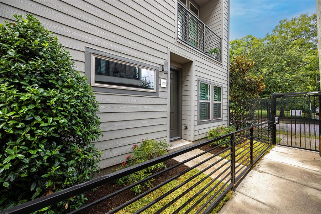 4226 Roseland Avenue, Unit 201 Dallas, TX 75204 - Photo 20 of 24 a front view of a house with a garden