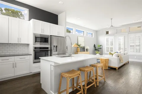 a kitchen with appliances a sink and cabinets