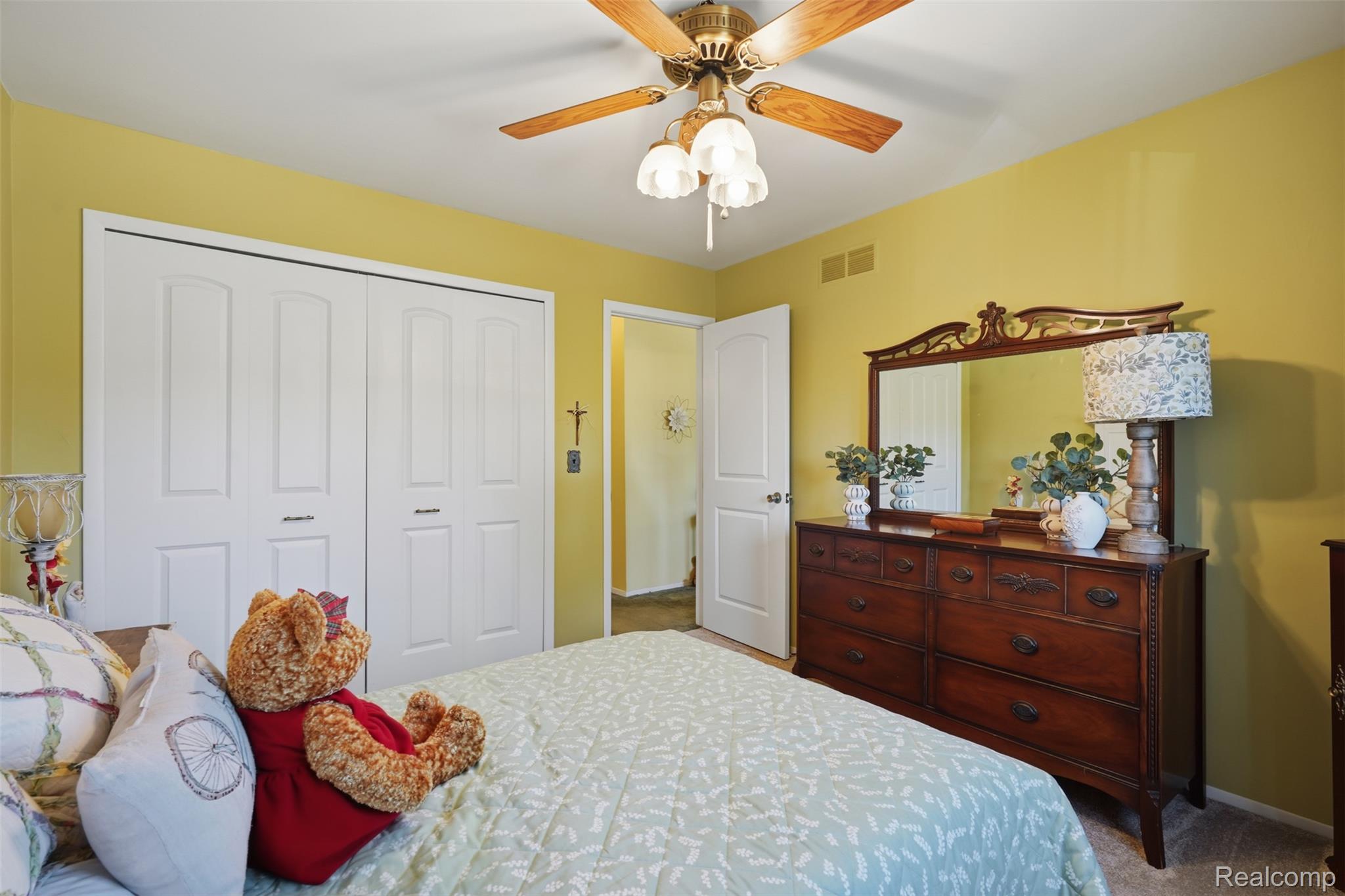 18160 Raleigh Square Drive Southgate, MI 48195 - Photo 20 of 31 Spacious bedroom featuring bi-fold closet doors, a ceiling fan with integrated lighting, and neutral carpeting