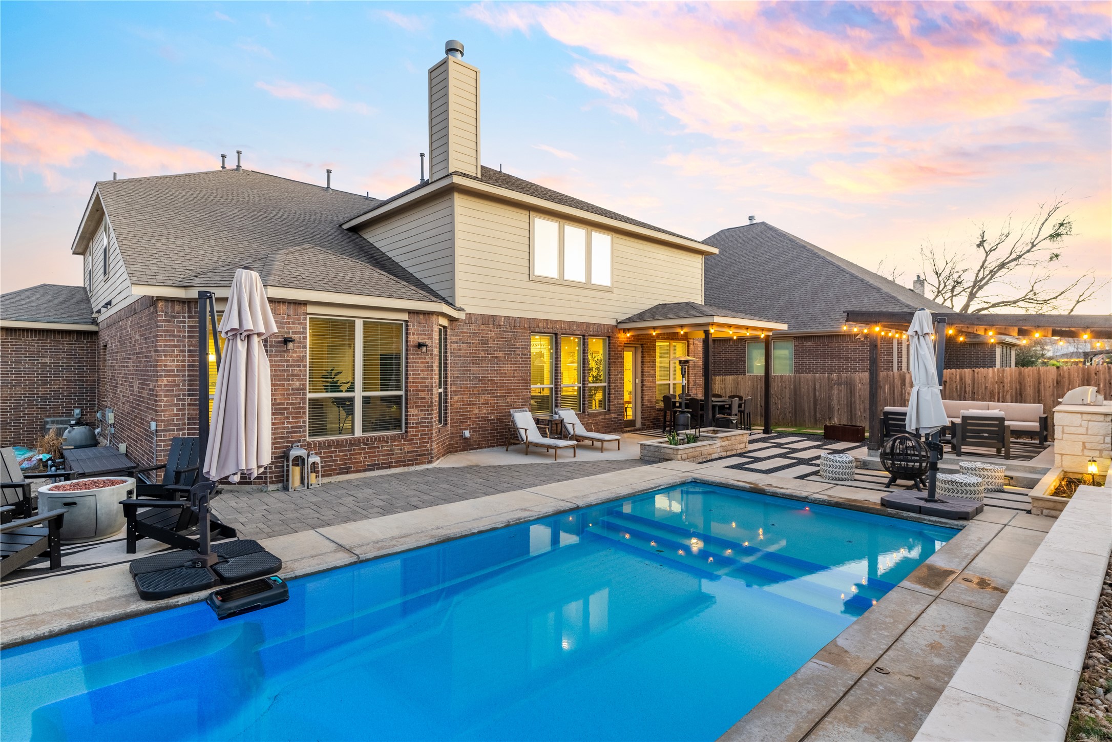 20524 Fairleaf Street Pflugerville, TX 78660 - Photo 31 of 35 Pool at dusk featuring a patio area and an outdoor living space with a fire pit
