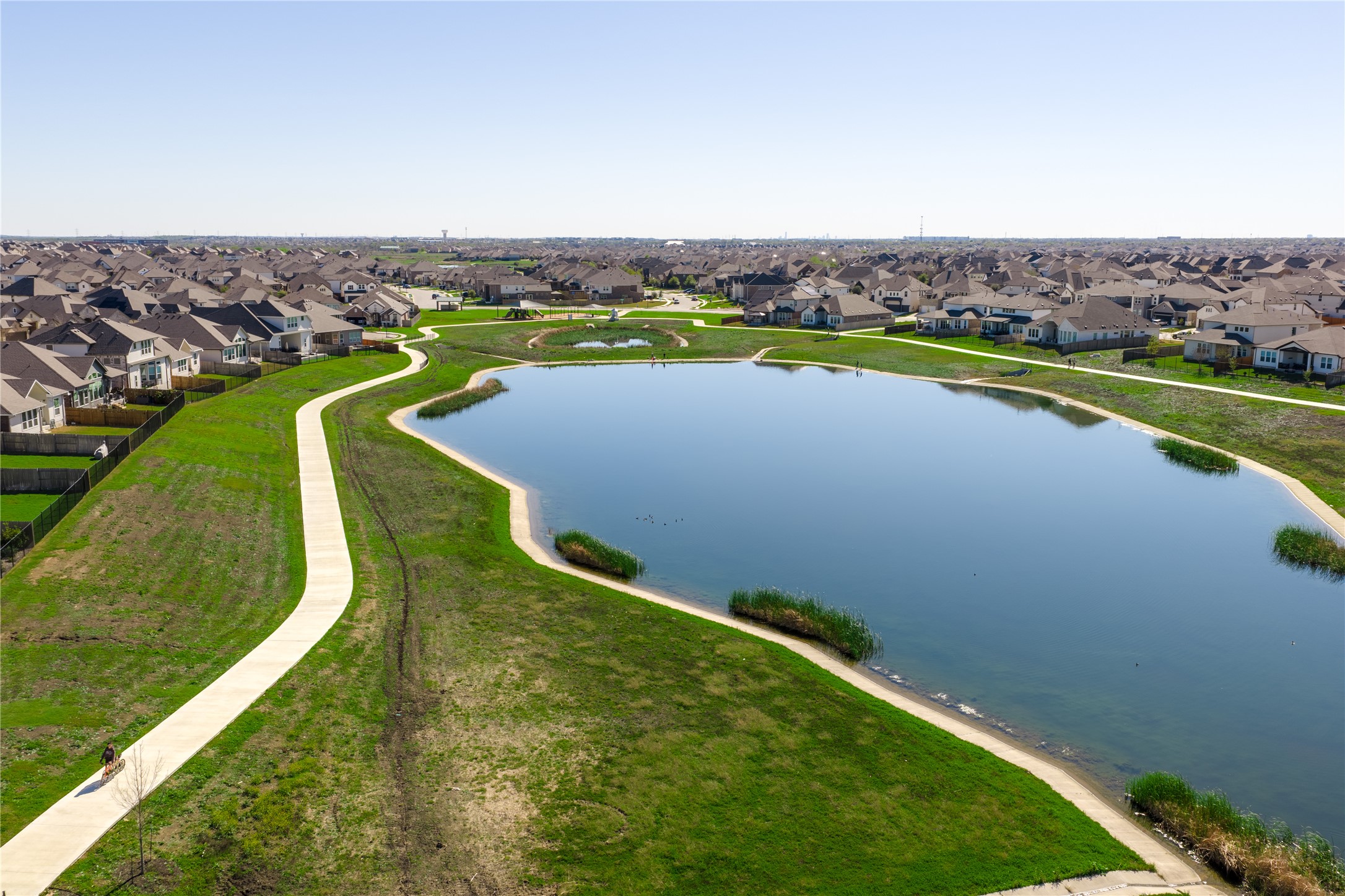 20524 Fairleaf Street Pflugerville, TX 78660 - Photo 35 of 35 Aerial perspective of suburban area featuring a large body of water