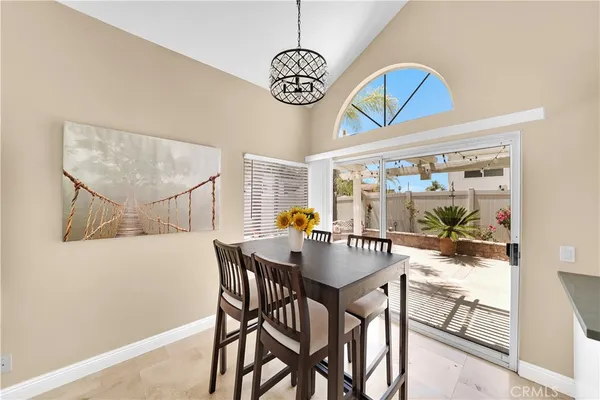 a view of a dining room with furniture wooden floor and a chandelier