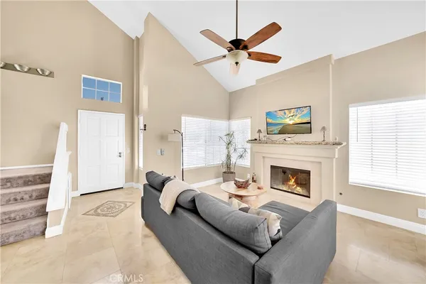 a living room with furniture a fireplace and a window