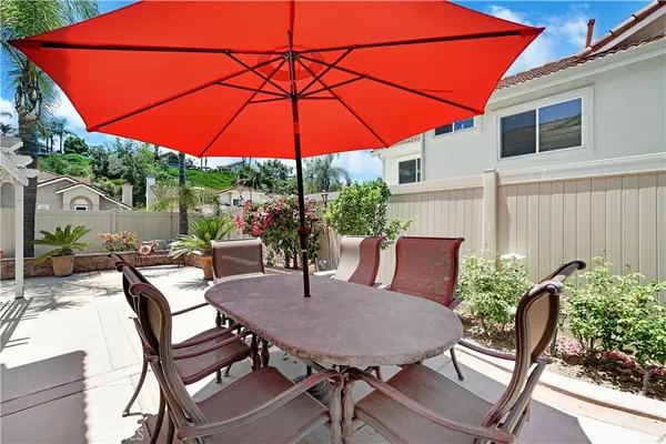 a view of an outdoor sitting area with furniture and umbrella